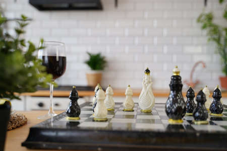 Close up of beautiful chess on table in room. Selective focus of porcelain chess pieces on chessboardの写真素材