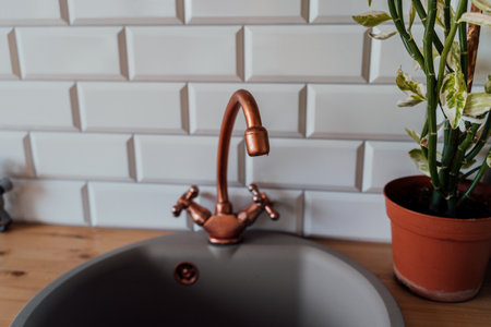 Close up of old kitchen faucet and sink. Shabby vintage tap in kitchenの写真素材