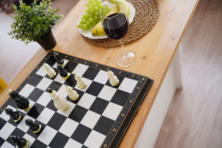 Close up of beautiful chess on table in room. Selective focus of porcelain chess pieces on chessboardの写真素材