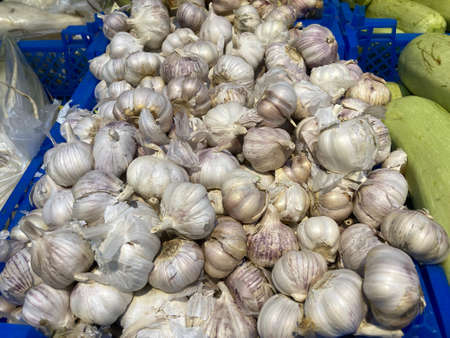 Close up of garlic in boxes on supermarket counter. Concept of agriculture, organic food and useful...
