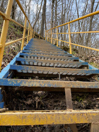 Close up of metal staircase in woodland. Metal stairway to overcome obstacles in mountainous terrain