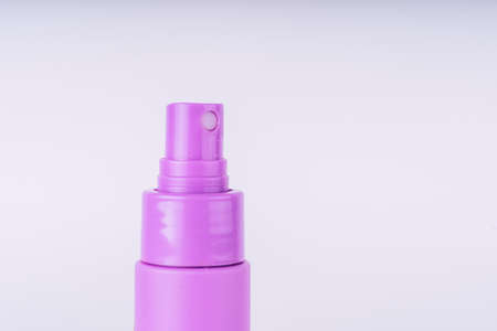 purple spray bottle on white background.の写真素材