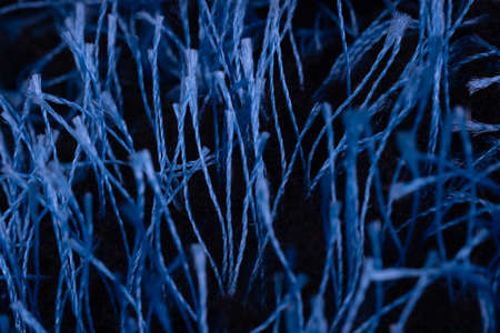 Close up of blue pile threads. Texture of yarn in macro