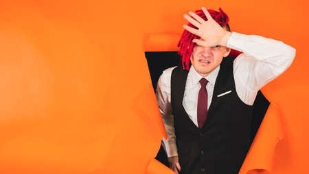 Perplexed male puts hand to head with imaginary fainting. Lifestyle concept and emotions of people.の写真素材