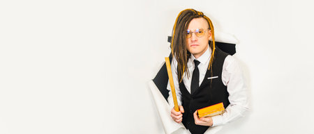 Male pedagogue with modern hairstyle, dreadlocks looking at camera in studio.の写真素材