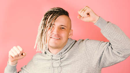 Young man with dreadlocks they dance expressively gesticulating with their hands. Male poses...