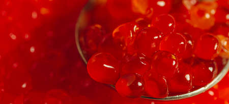 Spoon with fresh red caviar Trout caviar closeup. Russian delicacy.の写真素材