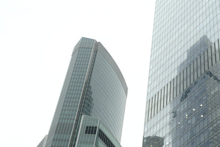 Facade of modern skyscraper with glass walls. From below of contemporary tall skyscraper with glass...