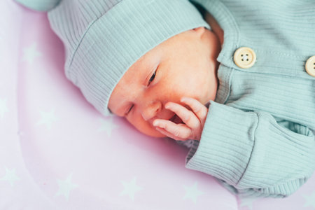 A newborn baby is resting in a cribの写真素材