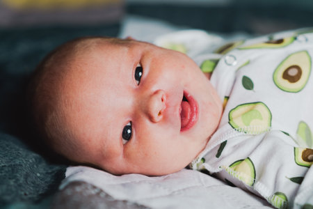 A newborn baby is resting in a cribの写真素材