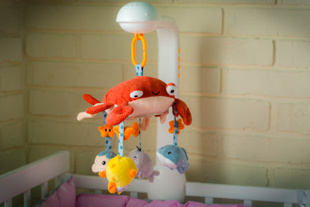 Mobile with soft toys in the crib. Mobile for baby. Children's Toy Red Crab