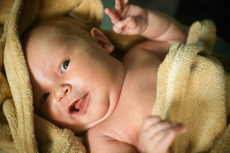 Cute newborn lying in crib. portrait of calm infant.の写真素材