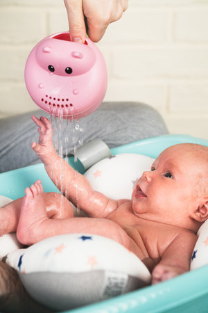 A newborn baby takes a bath. A lovely child is undergoing military training for the first time. The concept of children and hygieneの写真素材
