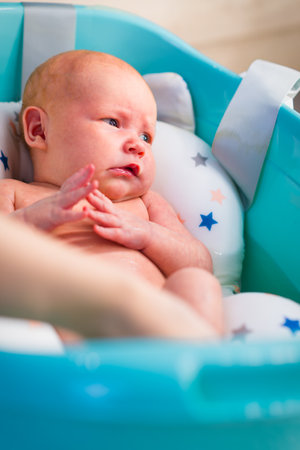 A newborn baby takes a bath. A lovely child is undergoing military training for the first time. The concept of children and hygieneの写真素材