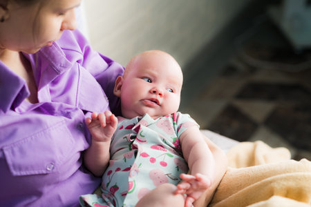 Portrait of a happy mother with her newborn baby at home.