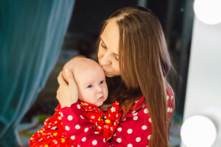 Portrait of a mother with her baby at home in the room