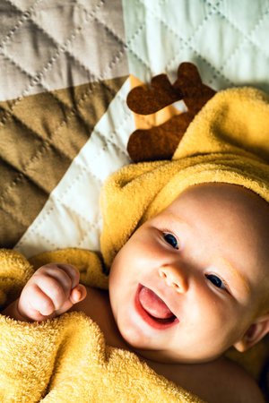 A newborn baby wrapped in a towel after bathing. The concept of childhood and infant careの写真素材