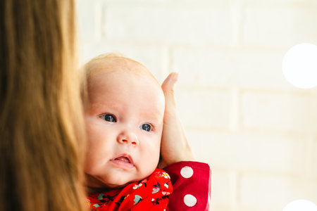 Newborn baby girl with mother in red dress. Newborn baby at home