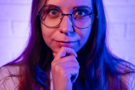 Portrait of a thoughtful young woman with glasses.の写真素材