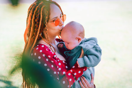 Mother and baby in the park. The concept of a happy family.の写真素材