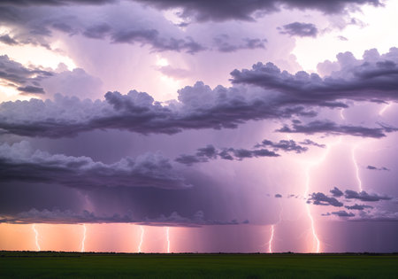 Thunderstorm over a green meadow. Dramatic sky with lightning.の素材