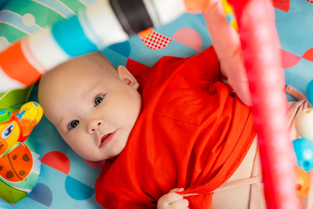 Portrait of cute baby a newborn girl playing in the roomの写真素材