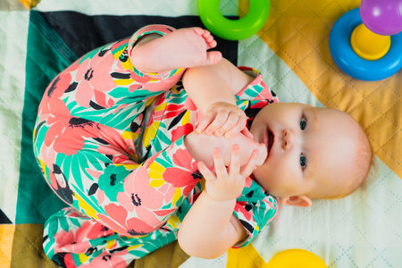 Portrait of a cute baby girl playing with a toy at home.