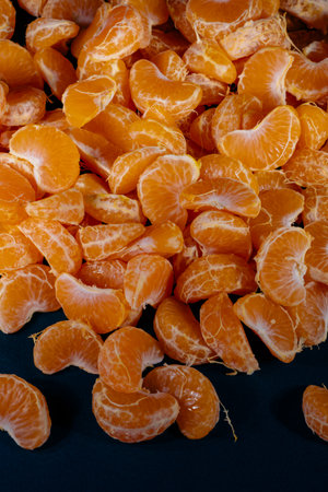 Peeled tangerines on a black background. Close-up.の写真素材