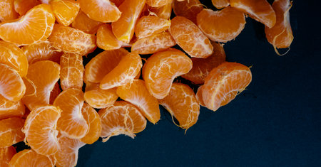 Peeled tangerines on a black background. Close-up.の写真素材