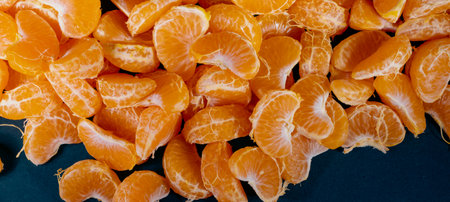 Peeled tangerines on a black background. Close-up.の写真素材