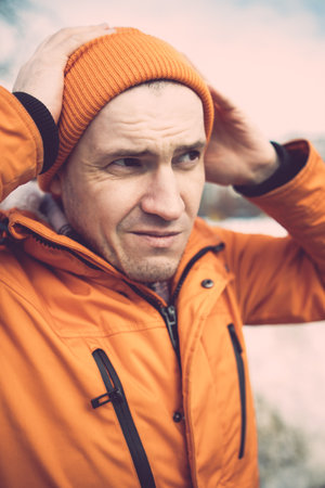 Man Wearing Orange Jacket and Beanie.の写真素材