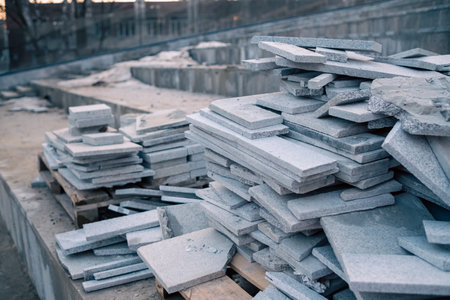 Piles of granite tiles ready for installation at a new building site at dawn