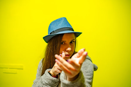 A woman in hat is energetically dancing