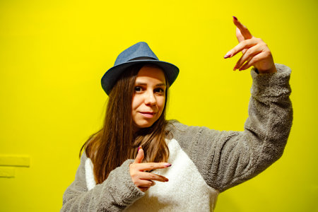 A woman in hat is energetically dancingの写真素材