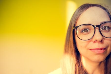 Woman With Glasses Smiling for the Camera. Her expression is joyful and engaging.