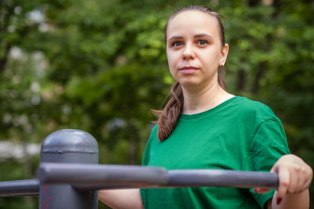 Woman Working Out on Outdoor Exercise Equipment in the Park.