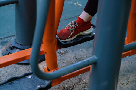 Woman Working Out on Outdoor Exercise Equipment in the Park.