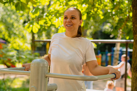 Woman Working Out on Outdoor Exercise Equipment in the Park.