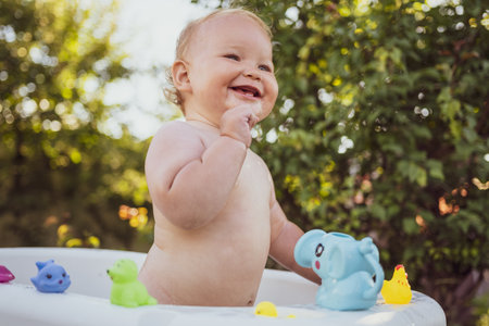 A Baby's Delightful Bubble Bath Adventure in the Summer Sun.の写真素材