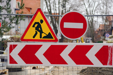 Roadwork Sign Displayed With Caution and Prohibition Indicators Near a Construction Site in an Urban Area During Winter Season.の写真素材
