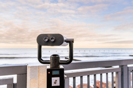 Beautiful Coastal View With Binoculars Highlighting the Serene Ocean Landscape at Sunset.の写真素材