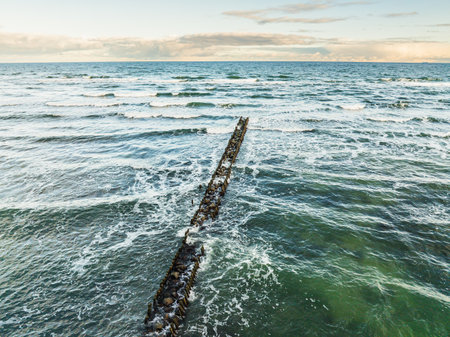 Calm Waves and Dramatic Clouds Over Serene Seascape During Late Afternoon Near Coastal Shore.の写真素材
