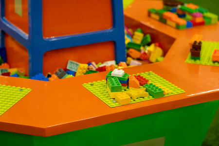 Colorful building blocks laid out for creative play in a cheerful indoor play area filled with imagination and fun for children.の写真素材