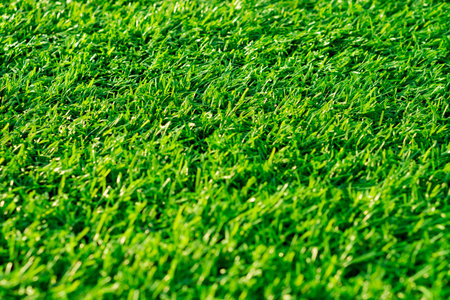 The artificial turf covers a football field offering a consistent and inviting surface for athletes...