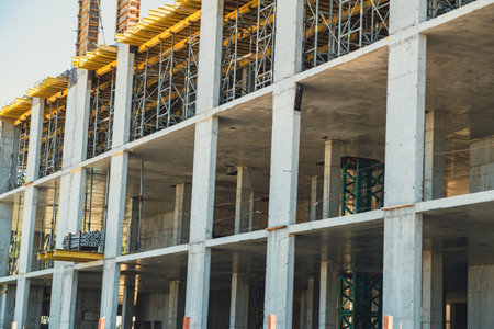 Construction progress of a modern building in an urban area during daylight hours.