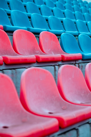 Red and Blue Stadium Seats Reflect the Preparation for an Upcoming Sports Event in an Empty Arenaの写真素材