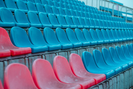 Red and Blue Stadium Seats Reflect the Preparation for an Upcoming Sports Event in an Empty Arenaの写真素材
