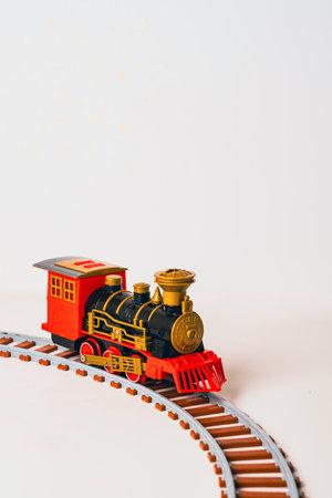 Colorful toy train on a curved track, showcasing vintage design and bright colorsの写真素材