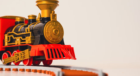 Colorful toy train on a curved track, showcasing vintage design and bright colors