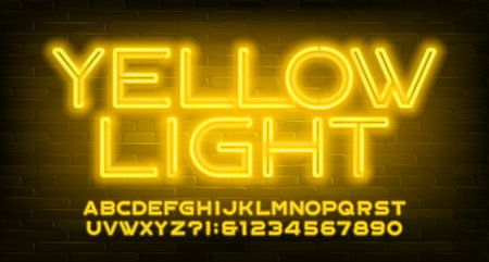 Yellow Light alphabet font. Neon light letters and numbers. Brick wall background. Stock vector typescript for your design.のイラスト素材